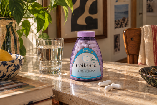 Collagen capsules and a smoothie on a kitchen counter in natural light